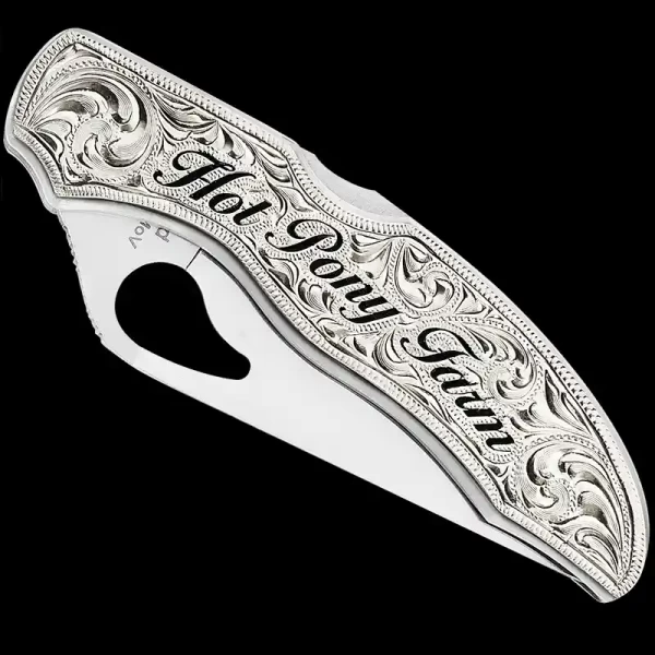 "Our Buffalo Plains Custom Knife is the perfect blend of rugged charm and masterful craftsmanship. Crafted using a SpyderCo Byrd knife and a German Silver plate, this custom knife features intricate hand-engraved details and hand-painted lettering as